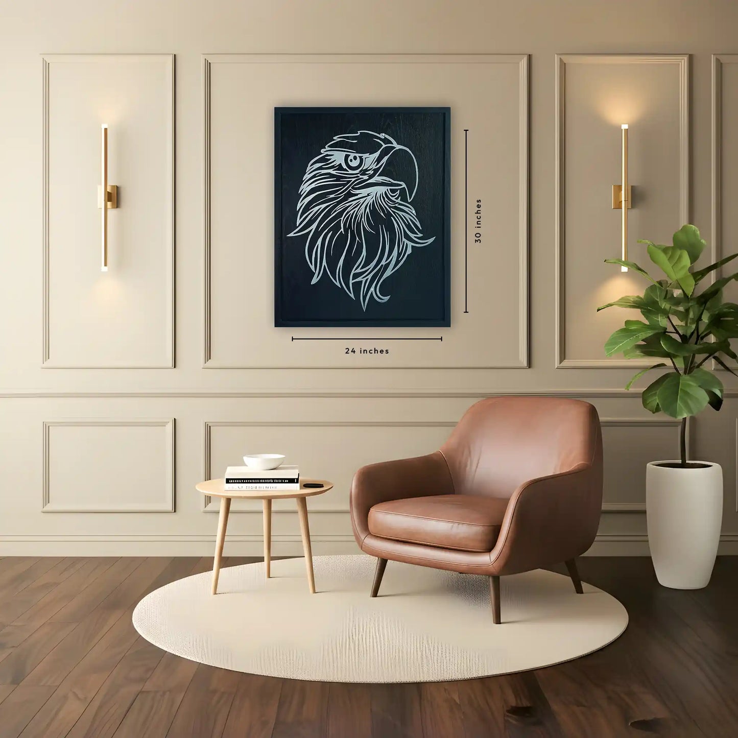 Modern living room with a brown leather chair, small table, and wooden framed with silver metal artwork of an eagle. Image shows the dimensions of 24 inches width and 30 inches tall.