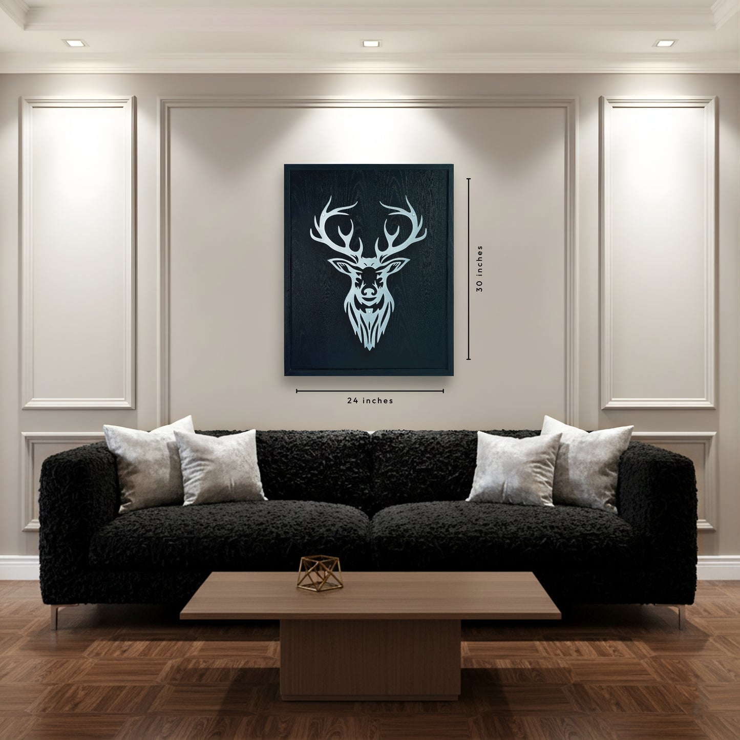 Modern living room with a black sofa, wooden coffee table, and deer head artwork on the wall.