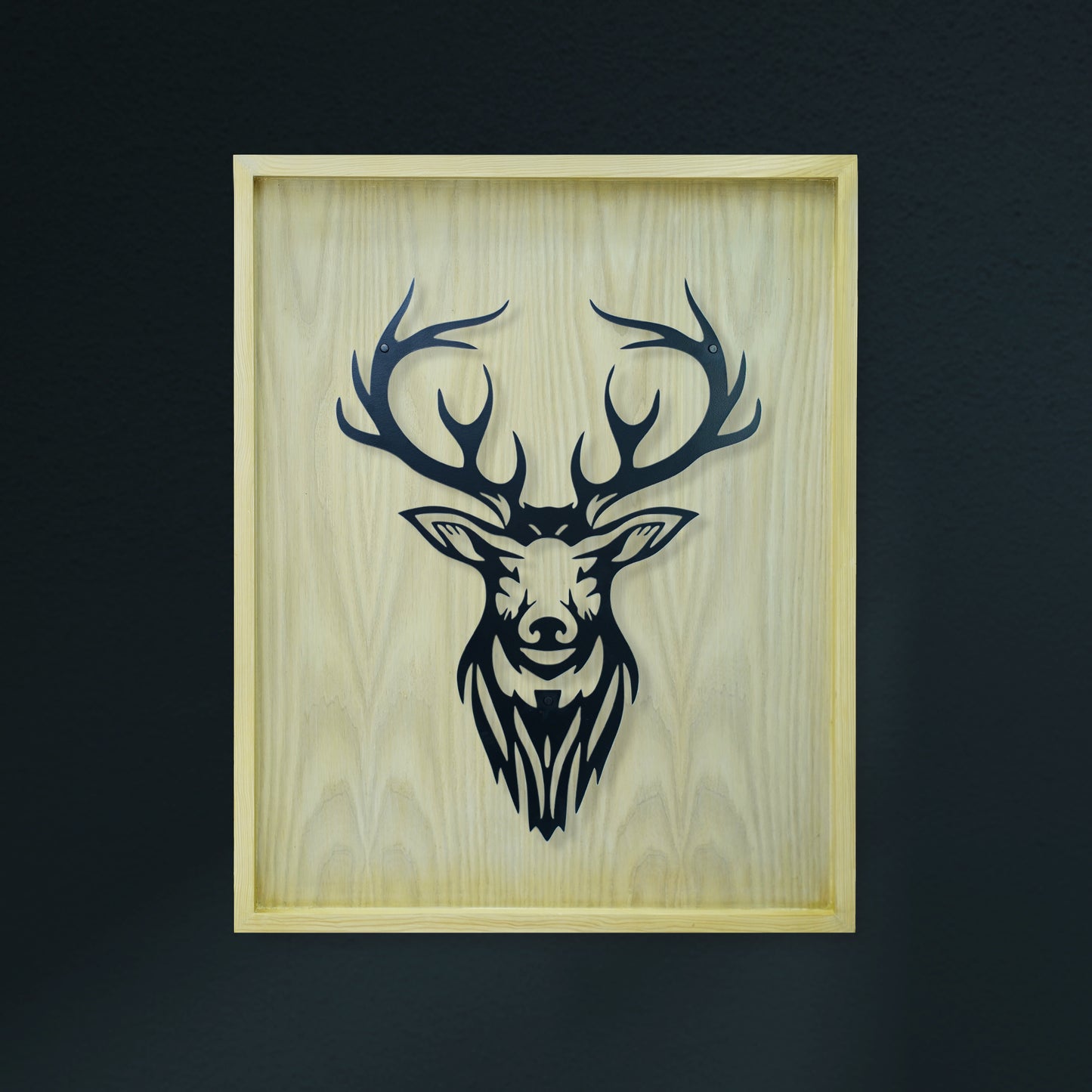 Wooden frame with black deer head design on a dark background