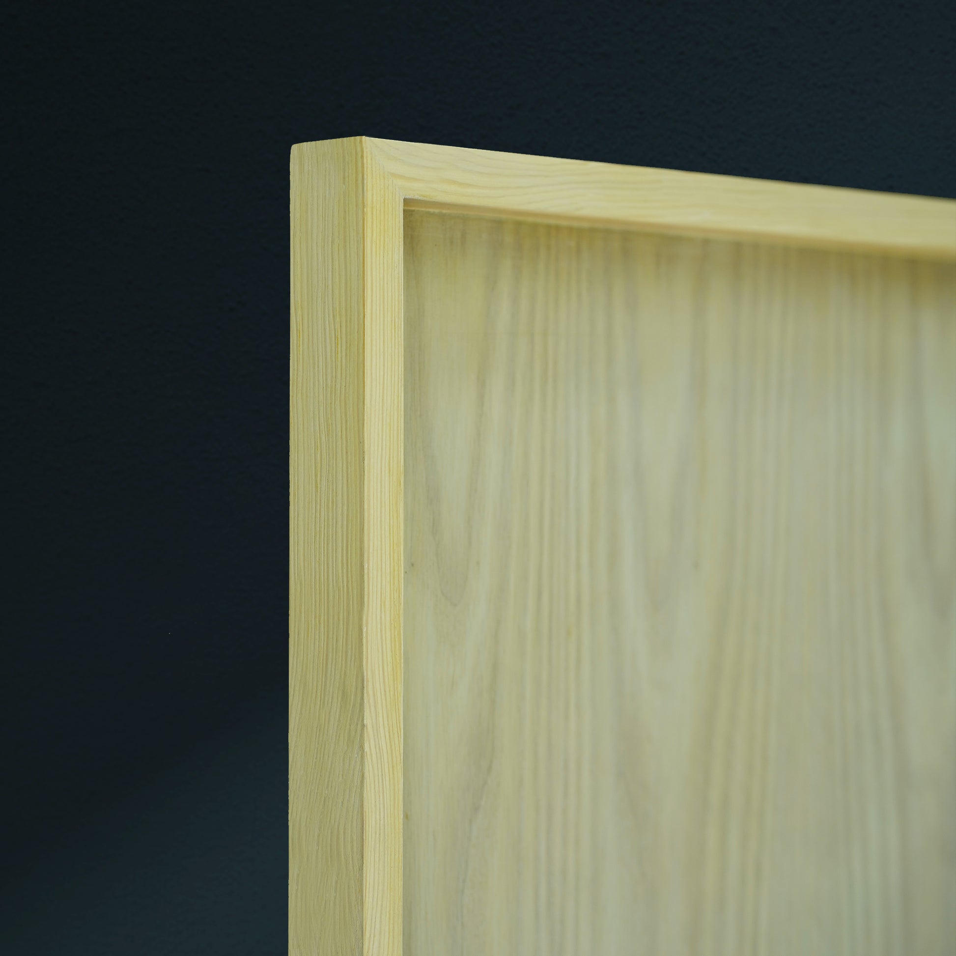 Close-up of a wooden frame with a dark background