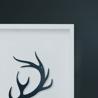 Black deer head silhouette on a white background with a dark gray border