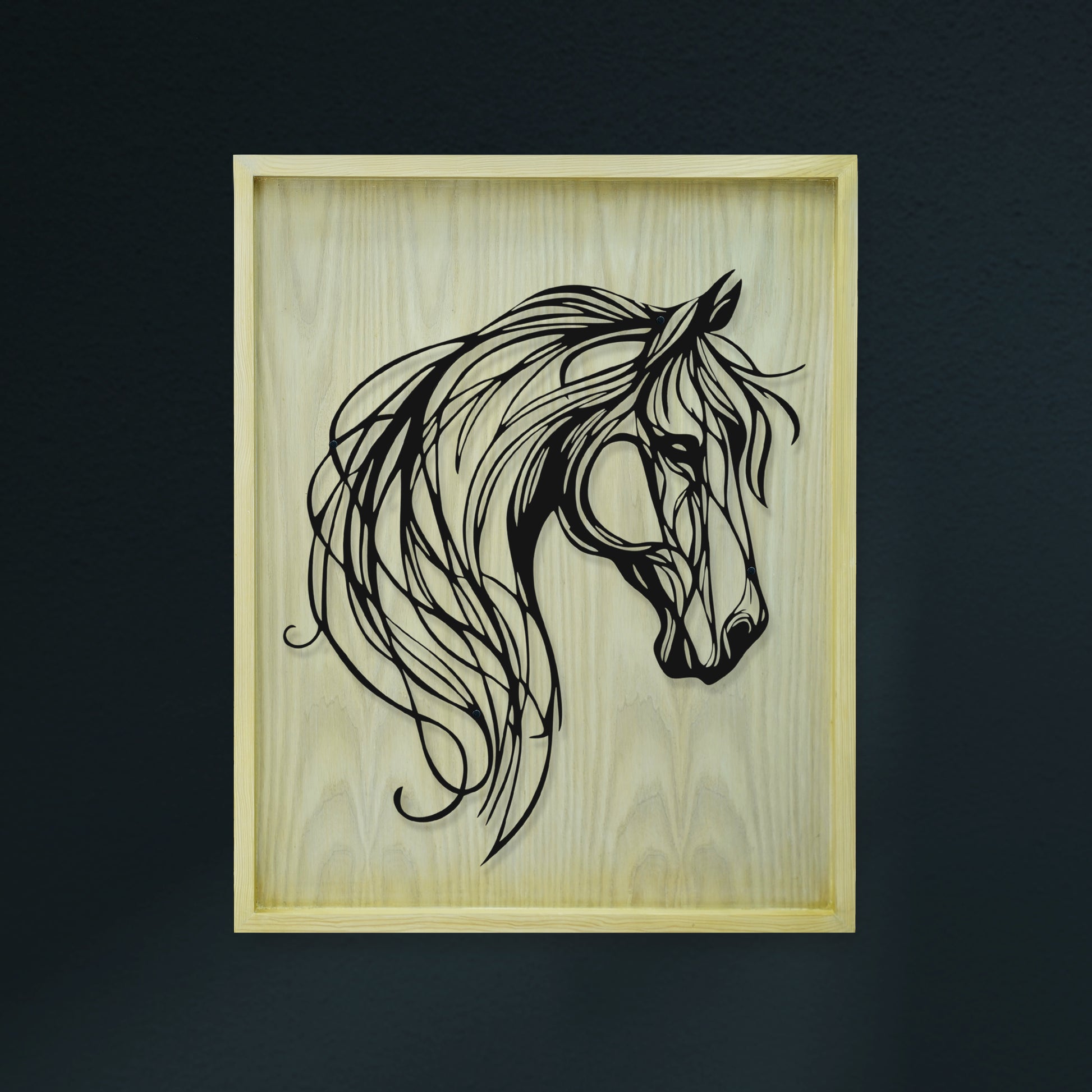 Framed artwork of a horse's head on a wooden background