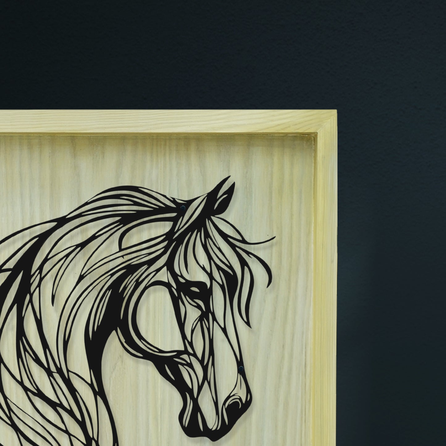 Framed artwork of a horse's head with a wooden frame on a dark background