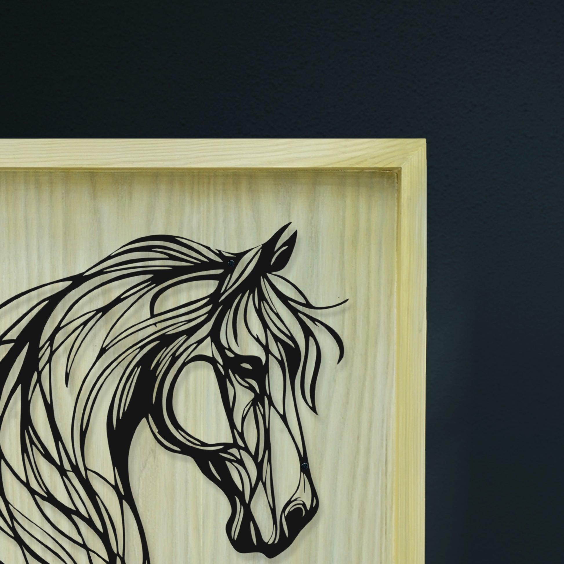 Framed artwork of a horse's head with a wooden frame on a dark background