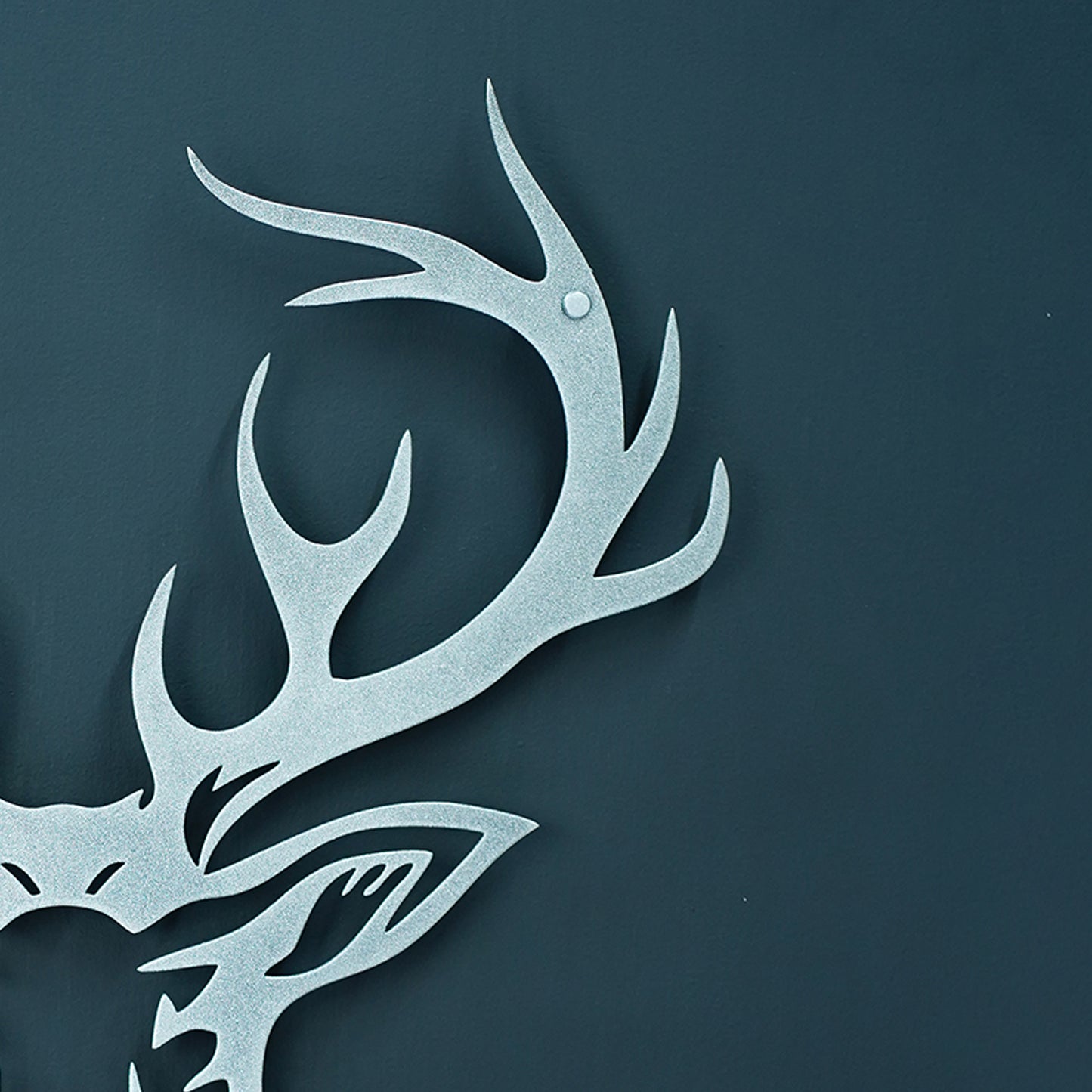 Metallic deer head with antlers on a dark blue background