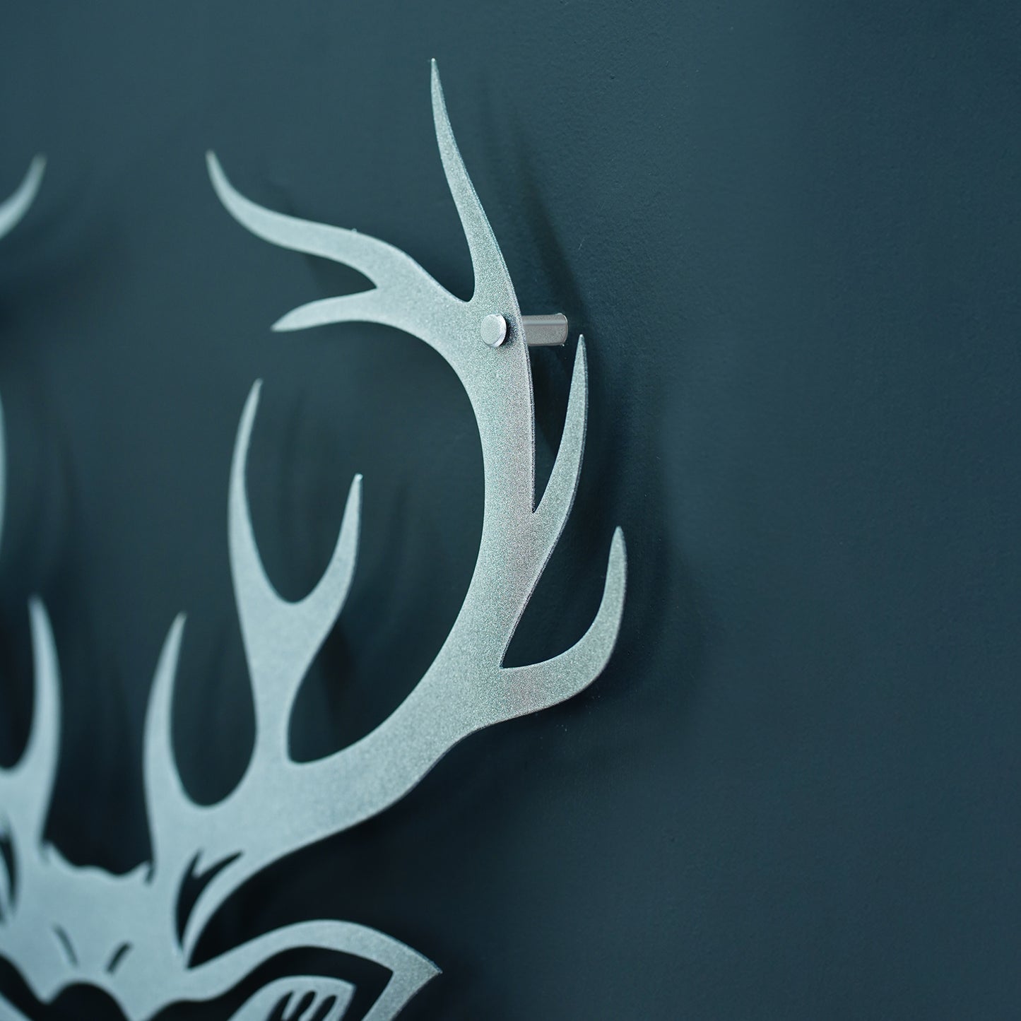 Metallic deer antler design on a dark background