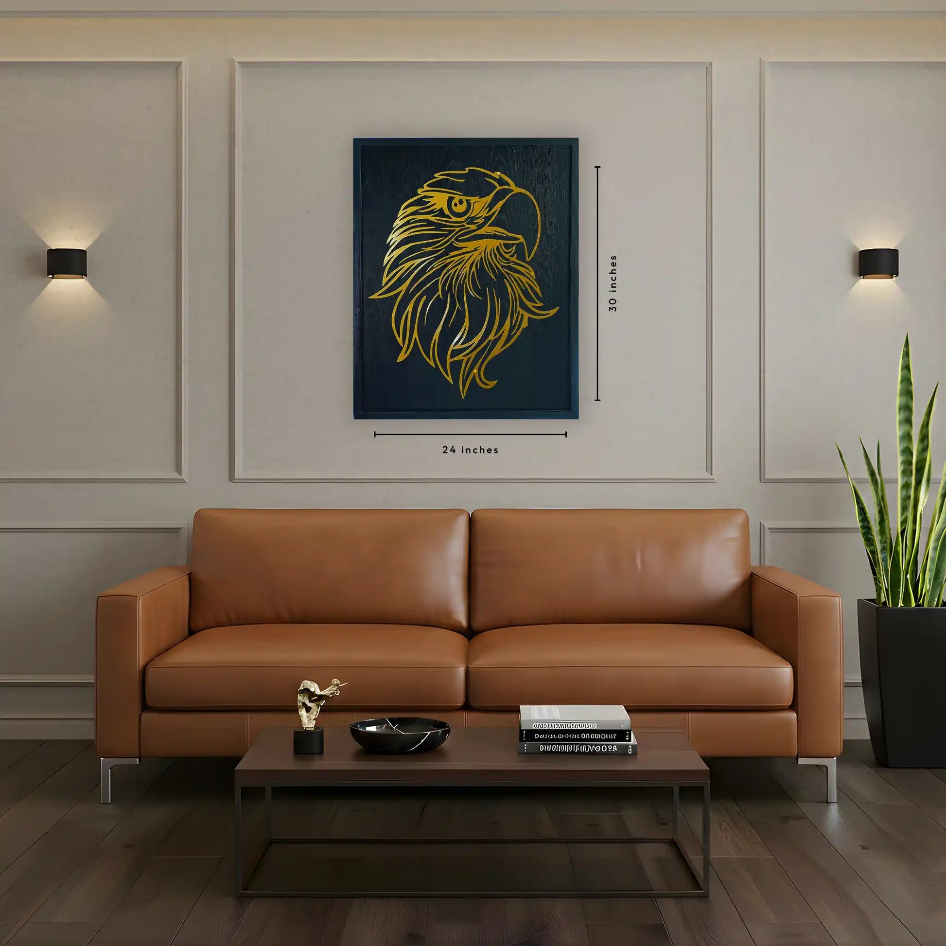 Brown leather sofa in a living room with a black wooden frame and golden metal wall art piece of eagle and decor items. image shows the dimensions of the frame which is 24 inches width and 30 inches tall