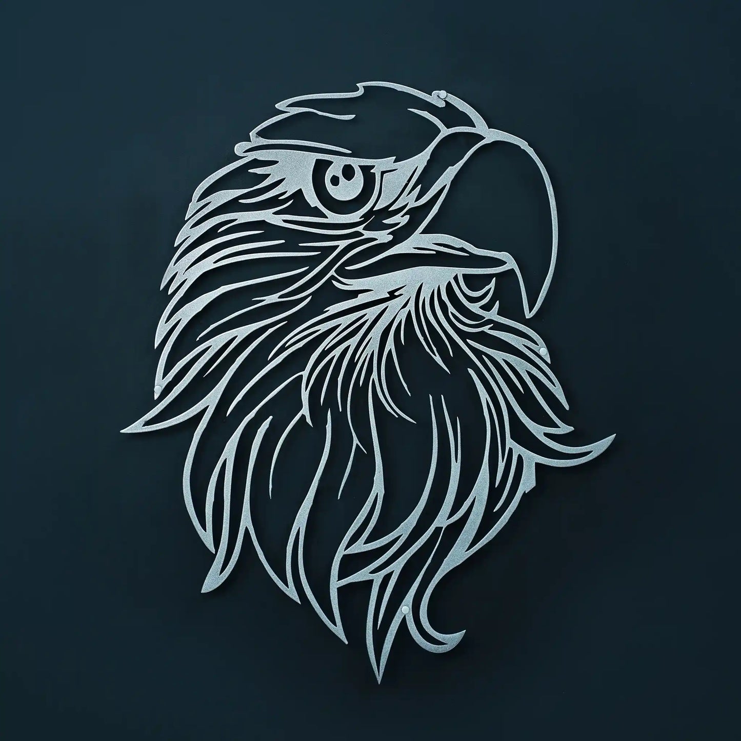 A stylized silver metal line-wall art illustration of an eagle head with a detailed eye and beak, centered on a dark navy background.