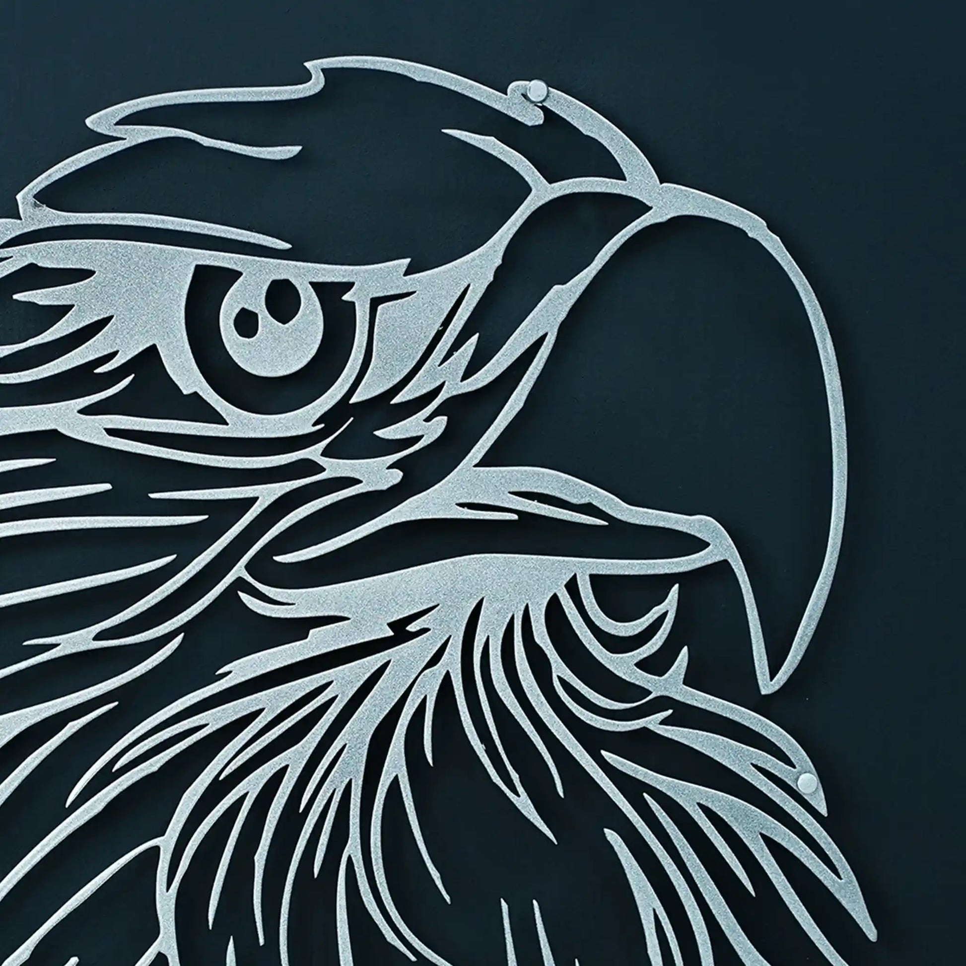 Metallic silver eagle art head design on a dark background