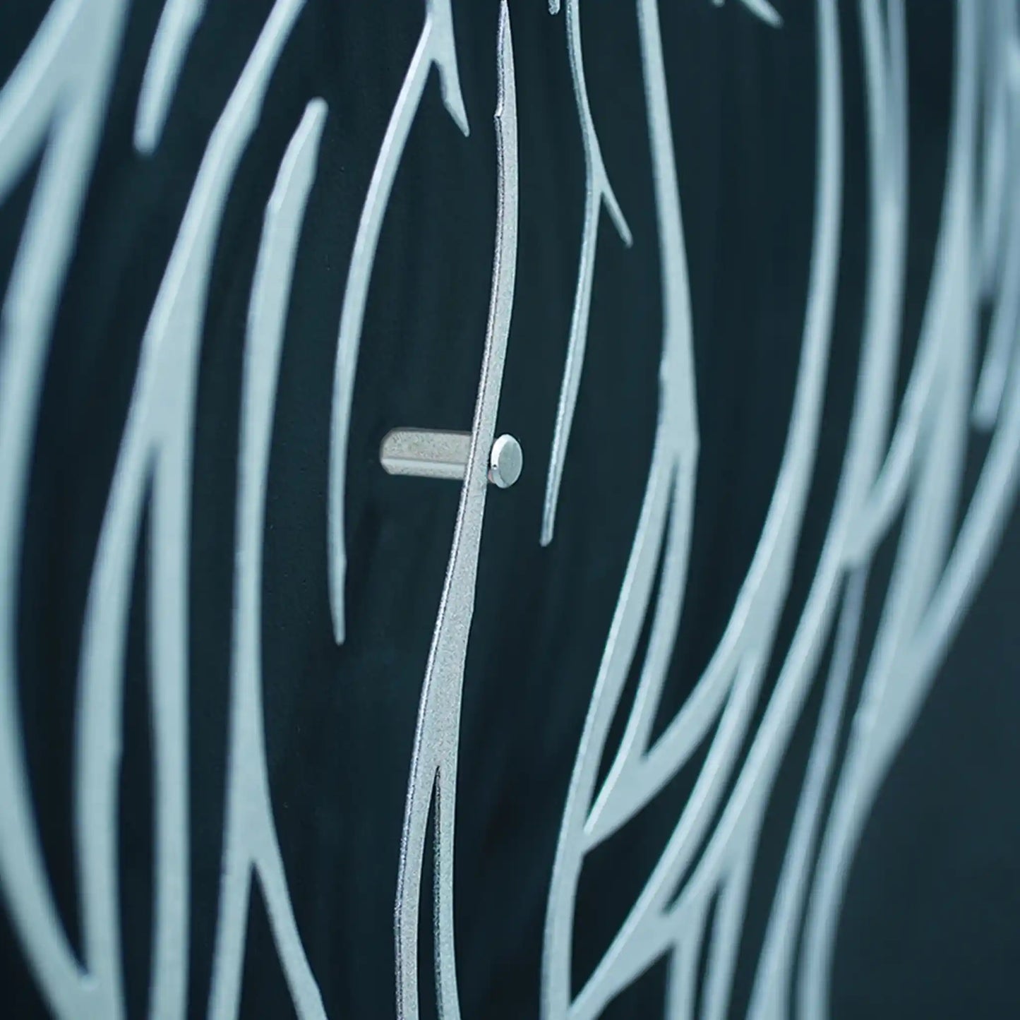 Close-up of Eagle feathers metal wall art and a small silver button or toggle at the center.