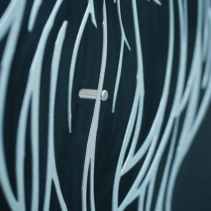 Close-up of Eagle feathers metal wall art and a small silver button or toggle at the center.
