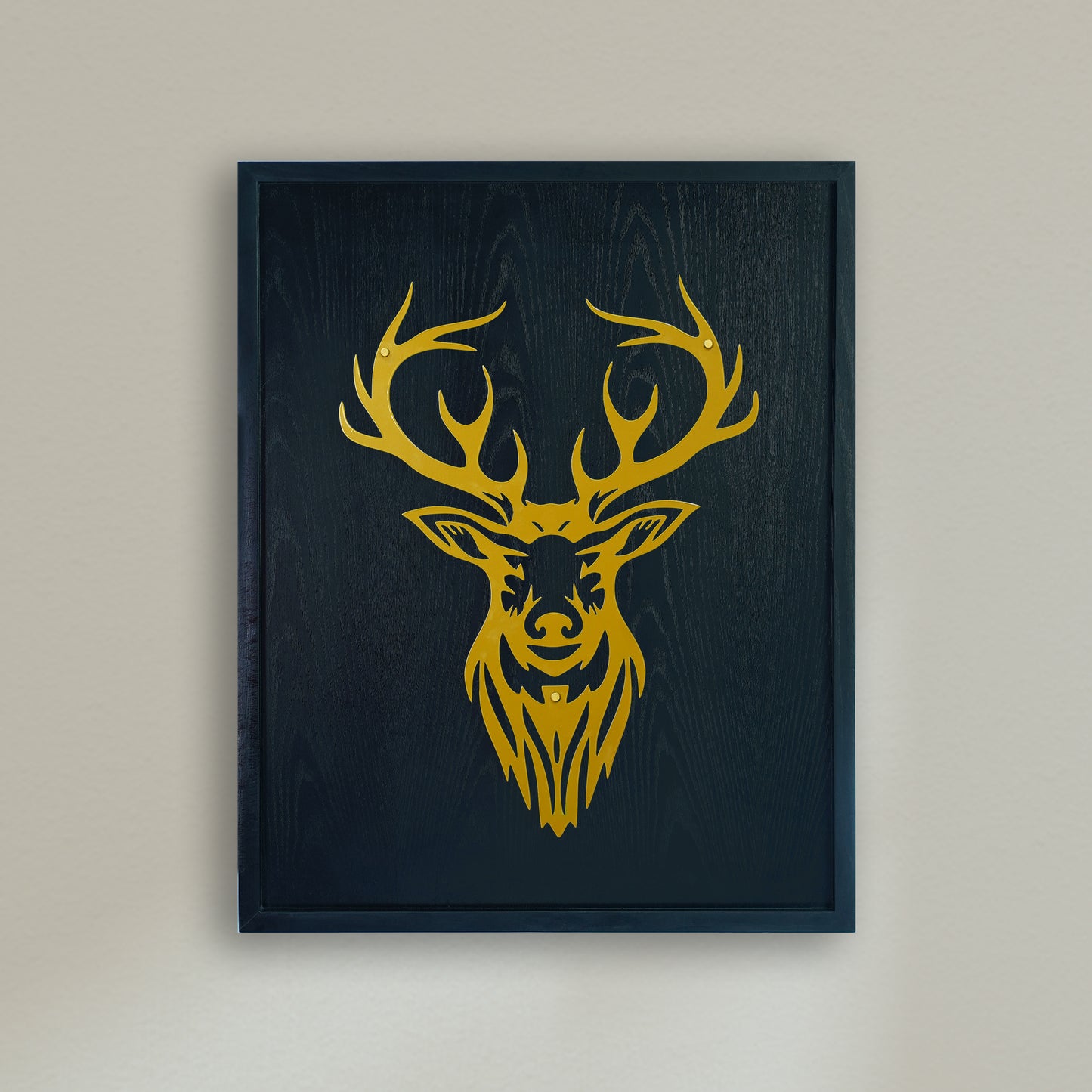 Framed artwork of a yellow deer head on a black background