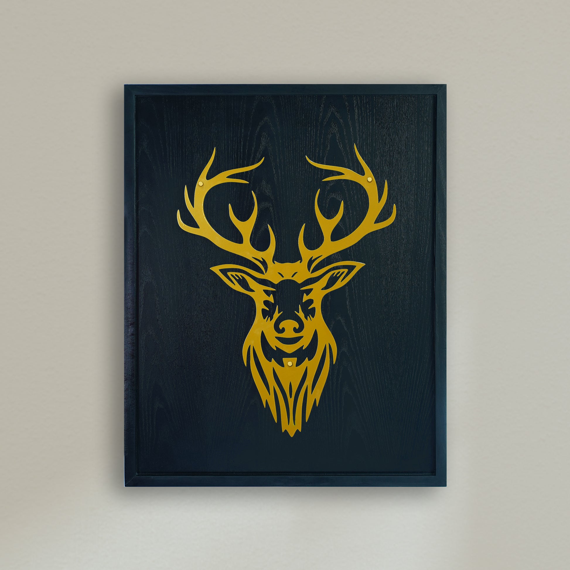 Framed artwork of a yellow deer head on a black background