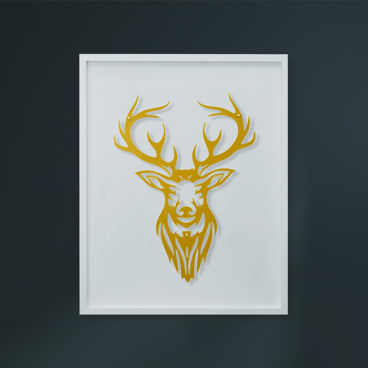 Framed artwork of a gold deer head on a white wooden frame