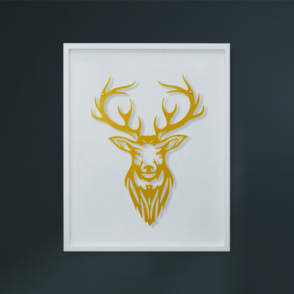 Framed artwork of a gold deer head on a white wooden frame