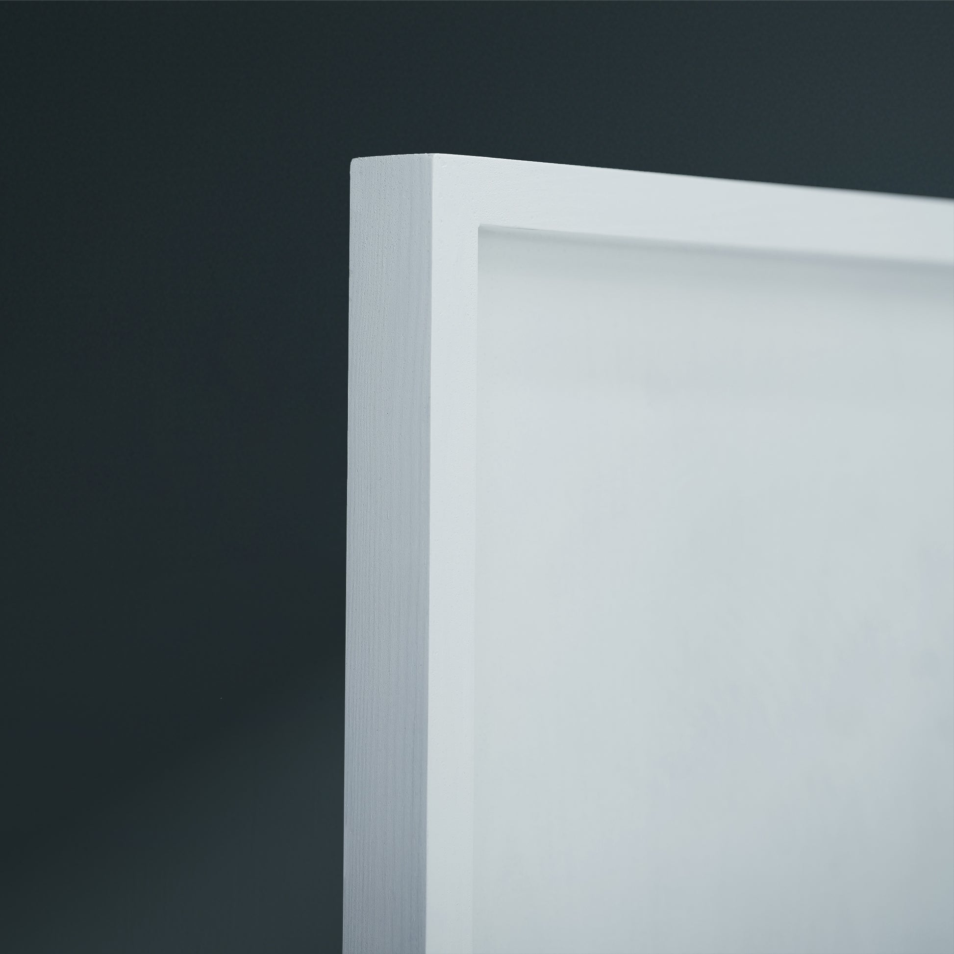 White wooden frame edge on a dark background