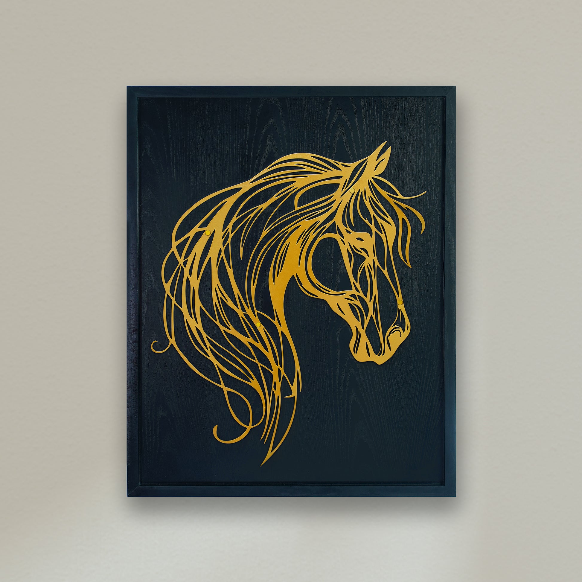 Framed artwork of a gold horse head on a black background