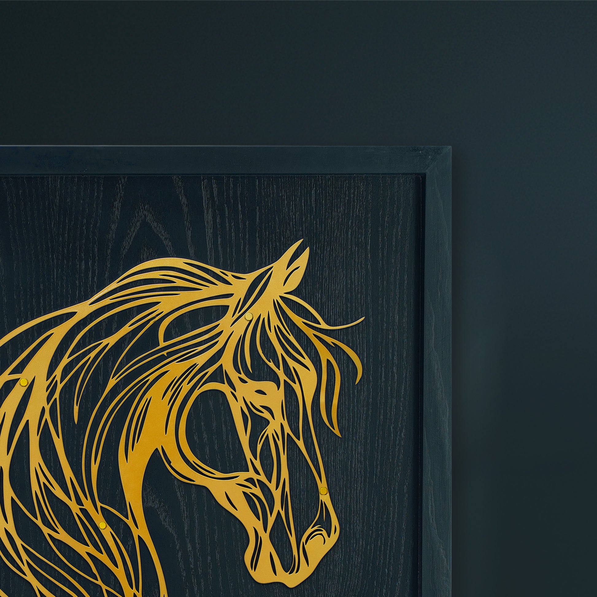 Framed artwork of a gold horse head on a dark background