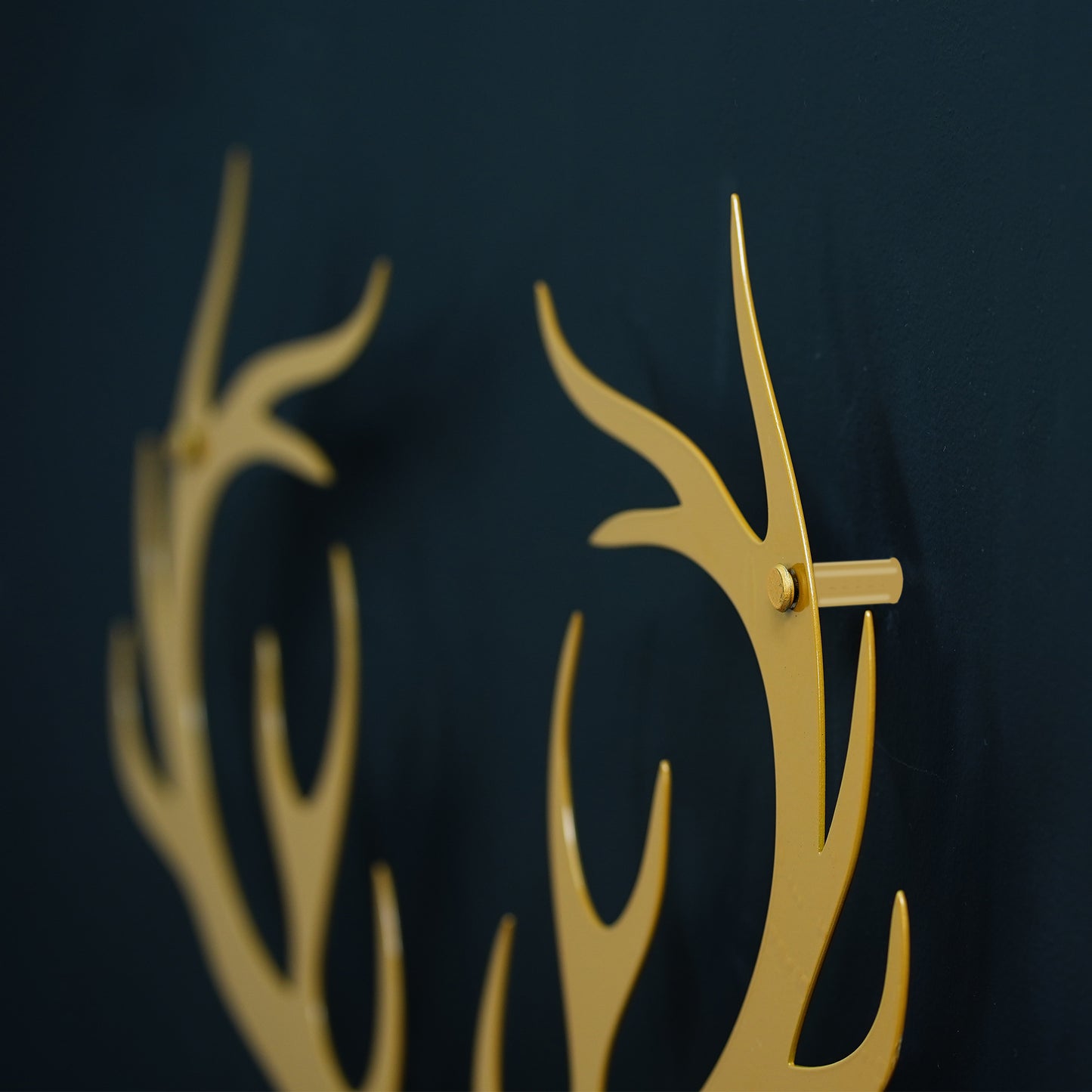 Gold antler-shaped deer on a dark background