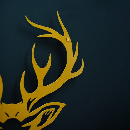 Gold deer head with antlers on a black background