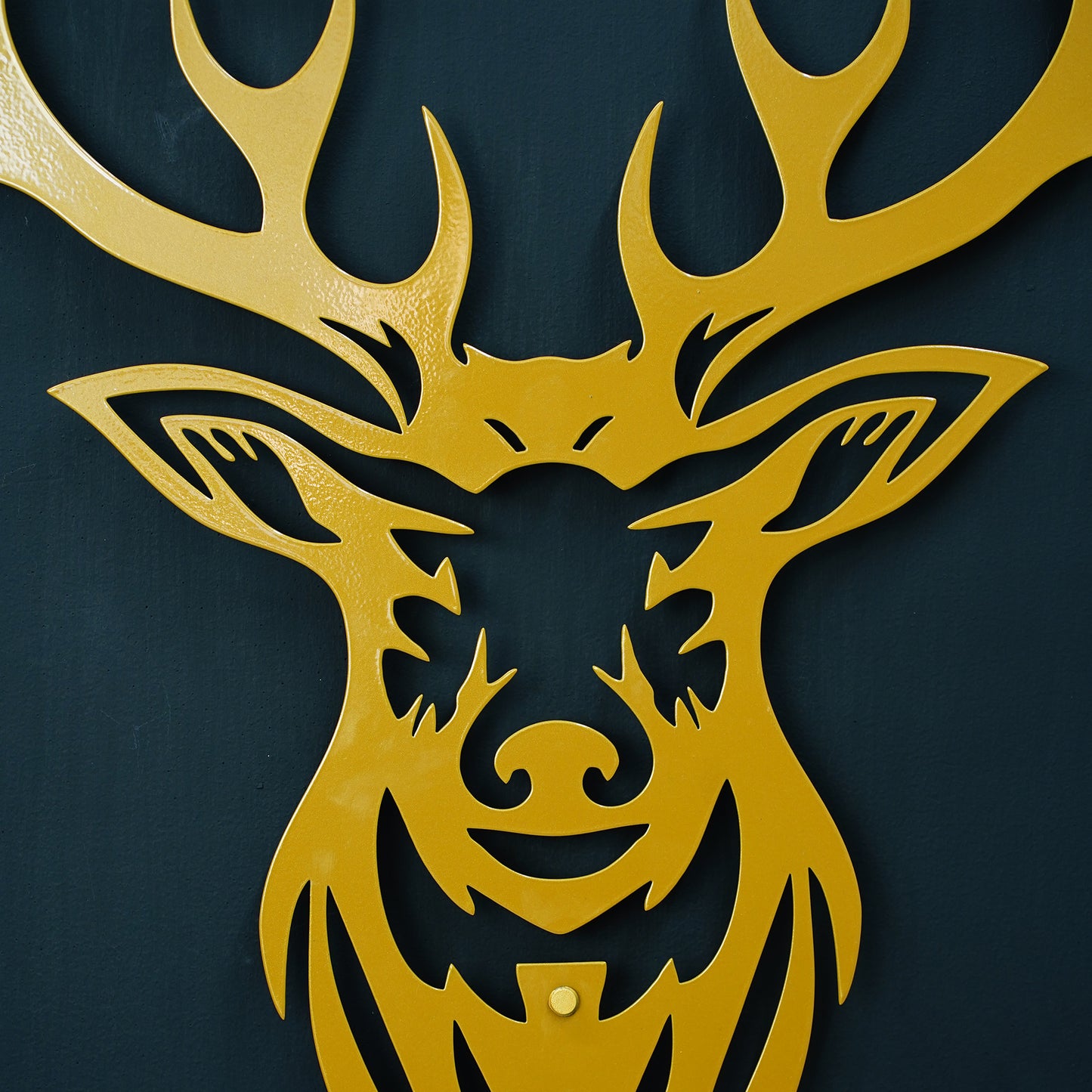 Gold deer head silhouette on a black background