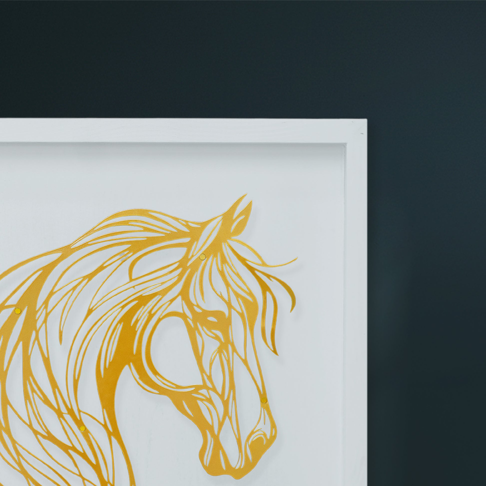 Framed artwork of a Golden horse head on a dark wall