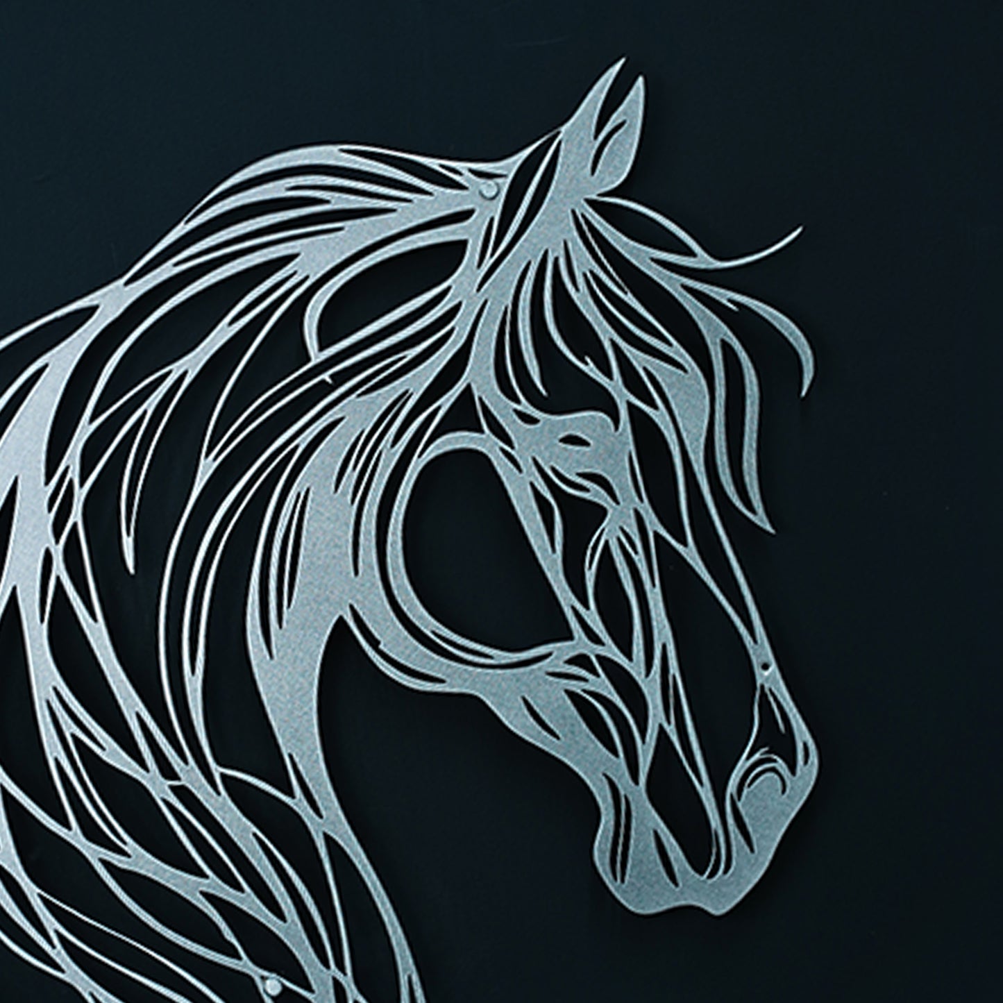 Metallic horse head design on a black background