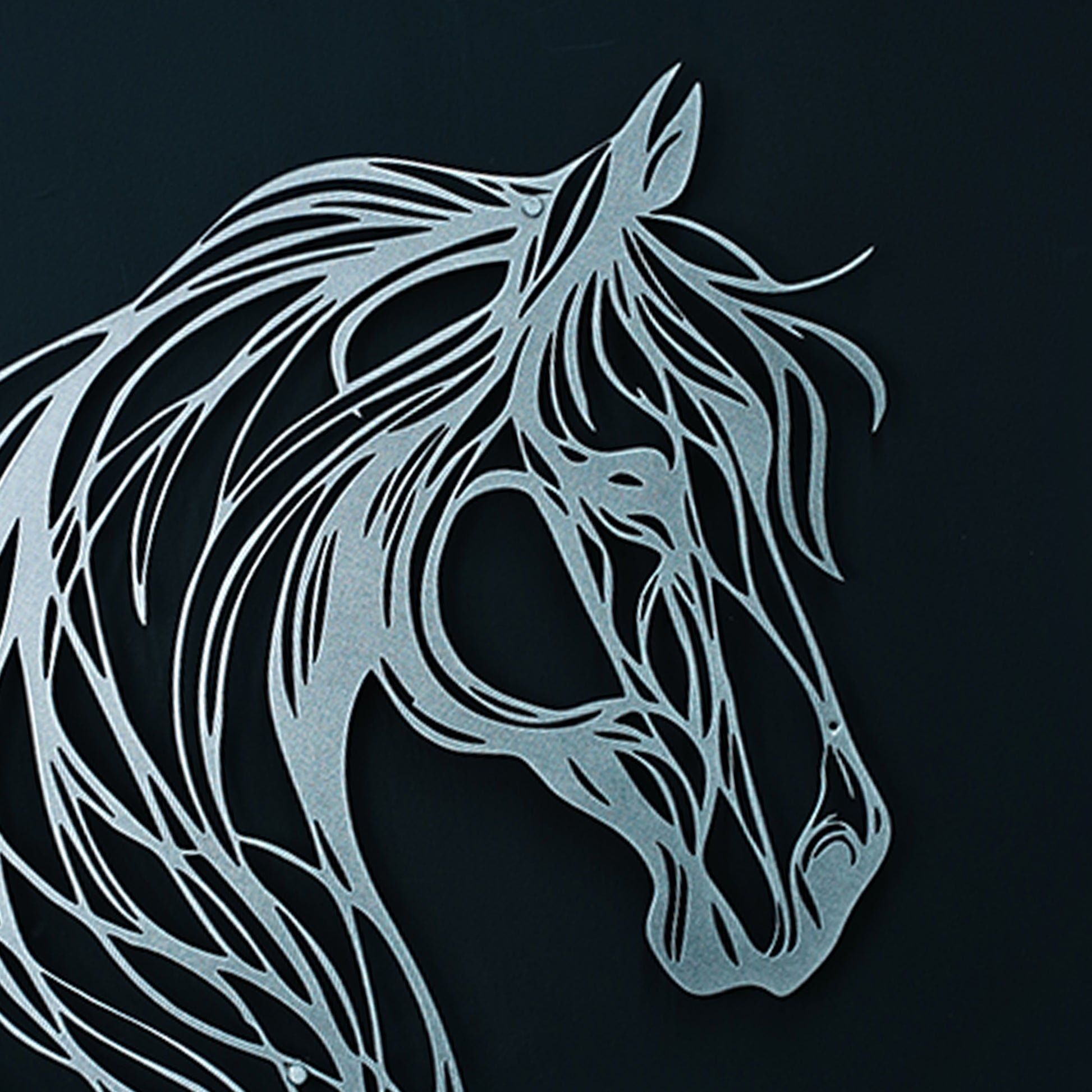 Metallic horse head design on a black background