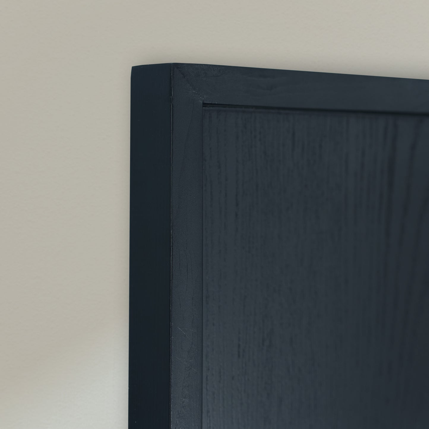 Black wooden frame on a beige color background