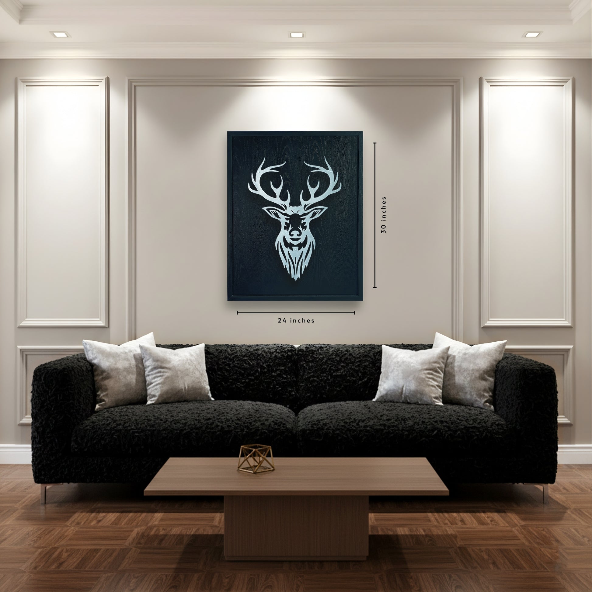 Modern living room with a black sofa, wooden coffee table, and deer head artwork on the wall.