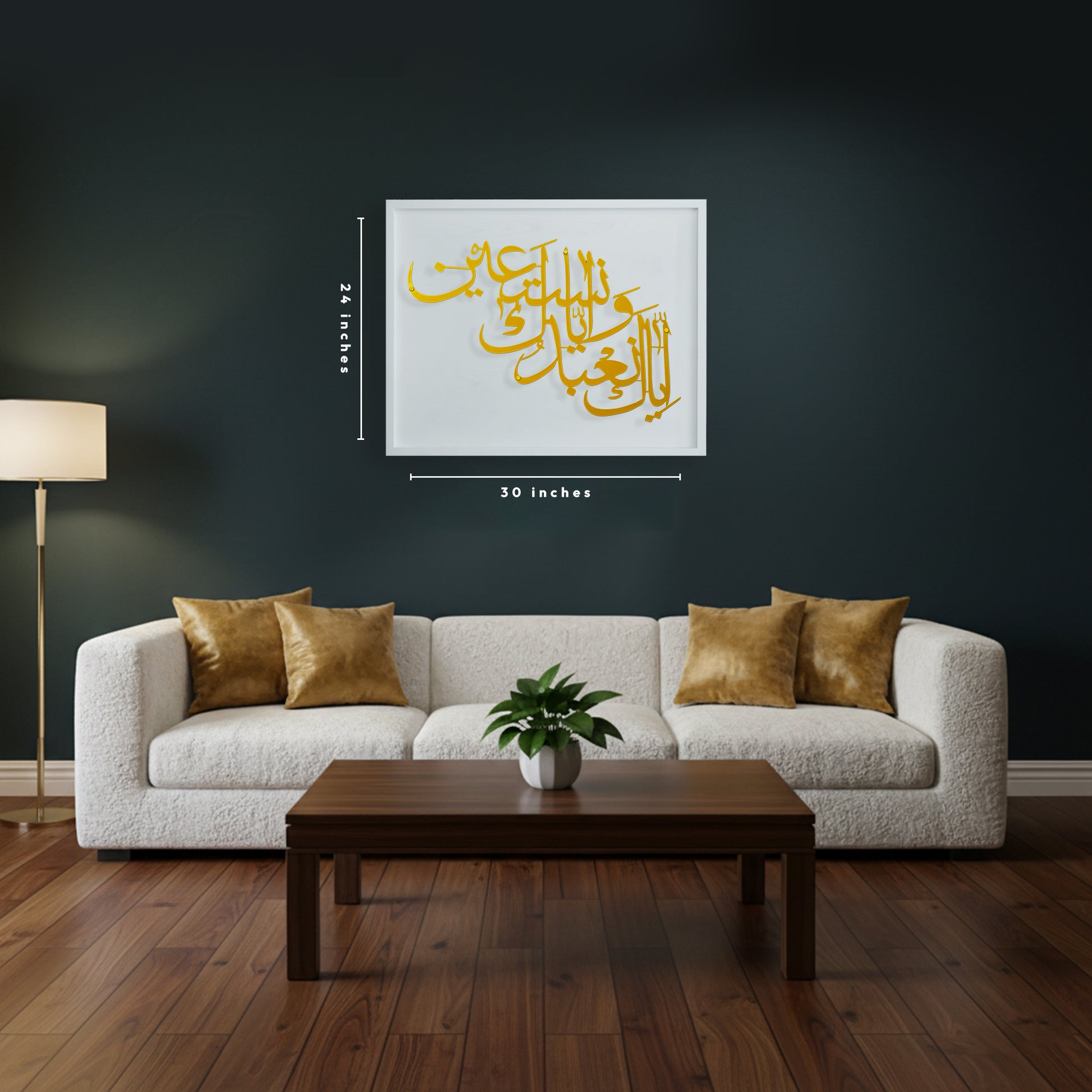 A framed Arabic calligraphy metal wall art in gold and white wooden frame is displayed above a white boucle sofa in a modern living room with a dark charcoal wall, wooden coffee table, and wood floor. Dimension lines indicate the print is 24 x 30 inches.