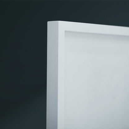 Close-up of a white frame corner against a dark charcoal background.